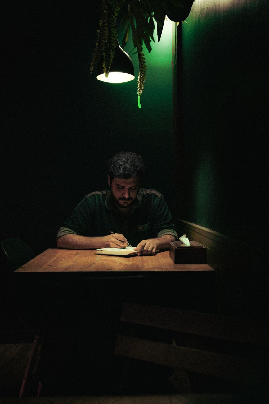 Travel journal editor reading in quiet cafe